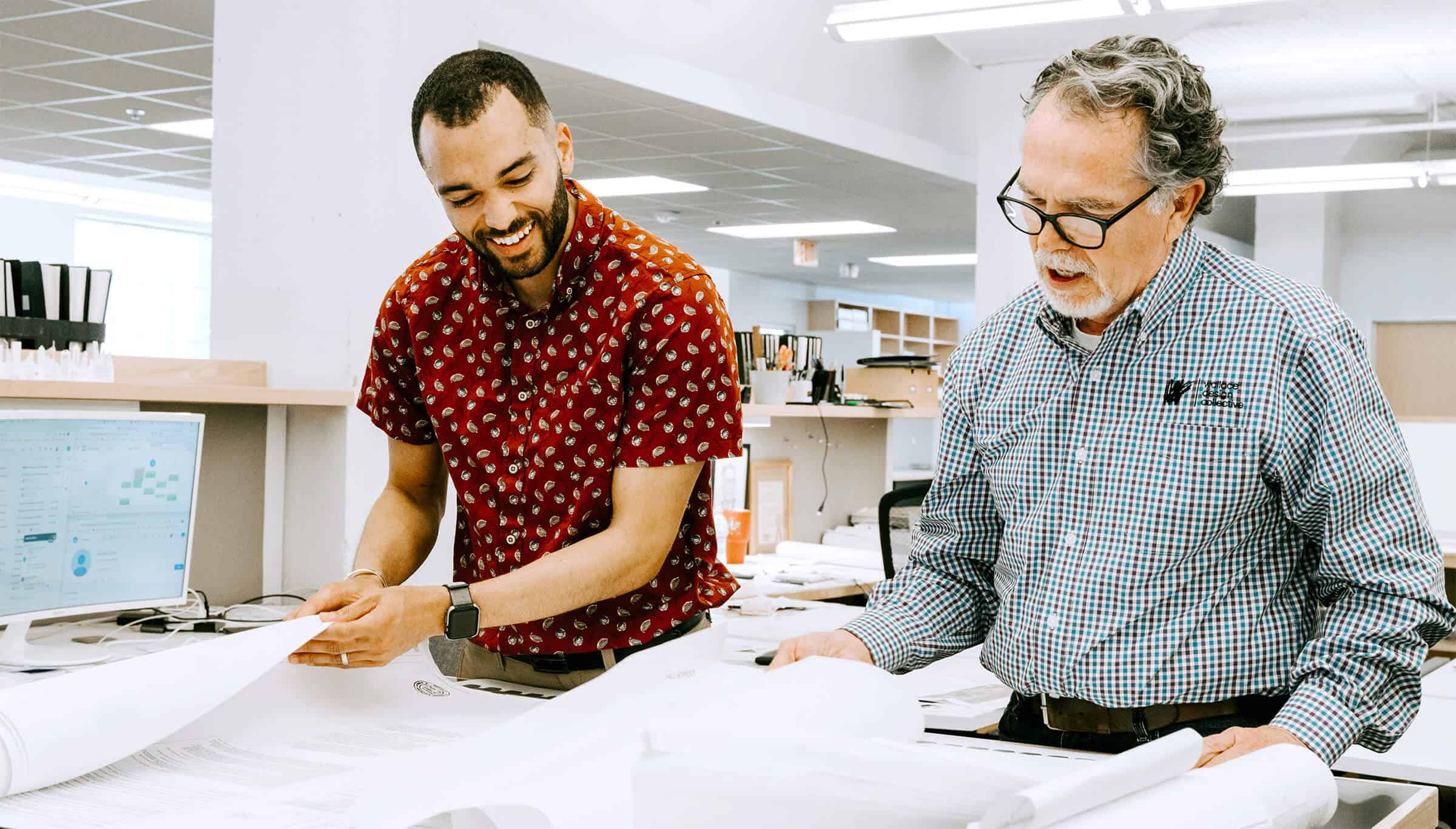 Wallace team members looking at sketches
