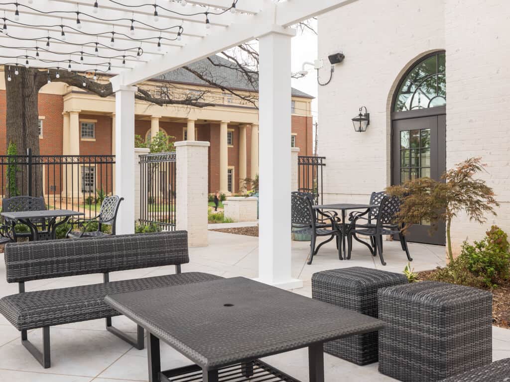 Outdoor patio with seating and landscaping at newly constructed sorority house