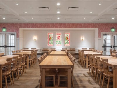 Spacious room with large wooden dining table and chairs for group sorority activities