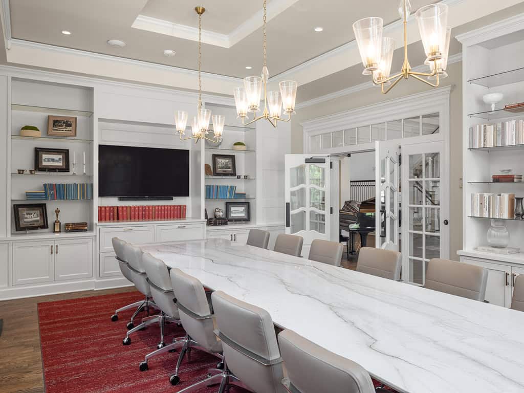 Study room with large white marble table and built-in bookshelves for studying or chapter meetings